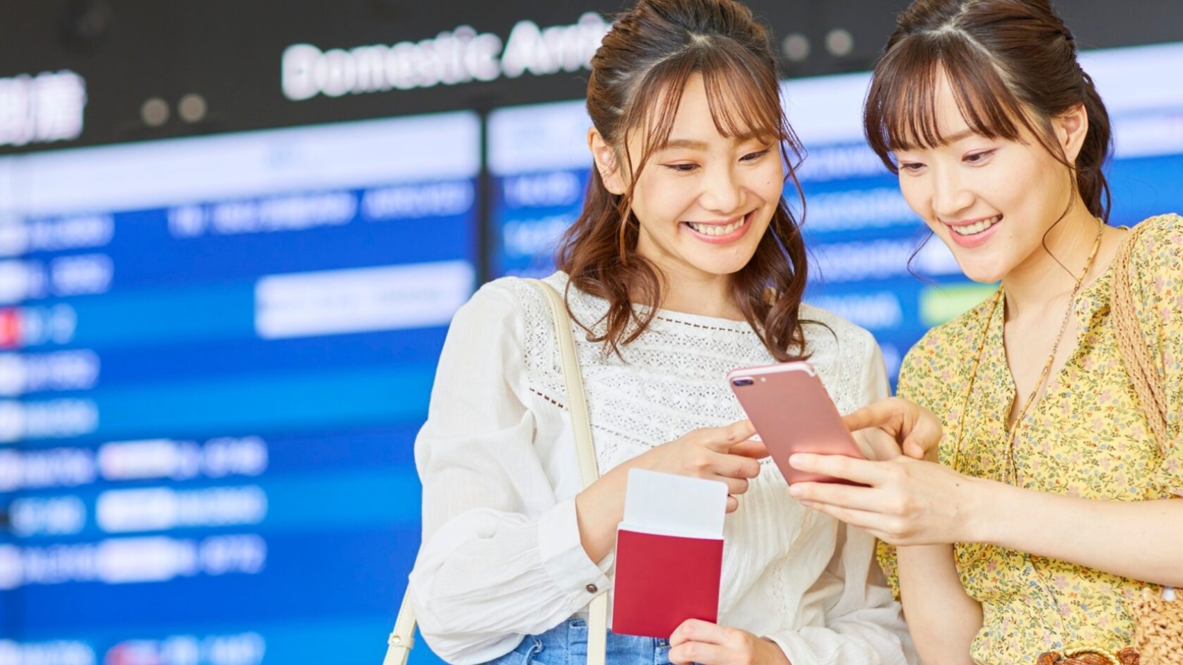 Passengers using mobile virtual assistant for flight updates at airport