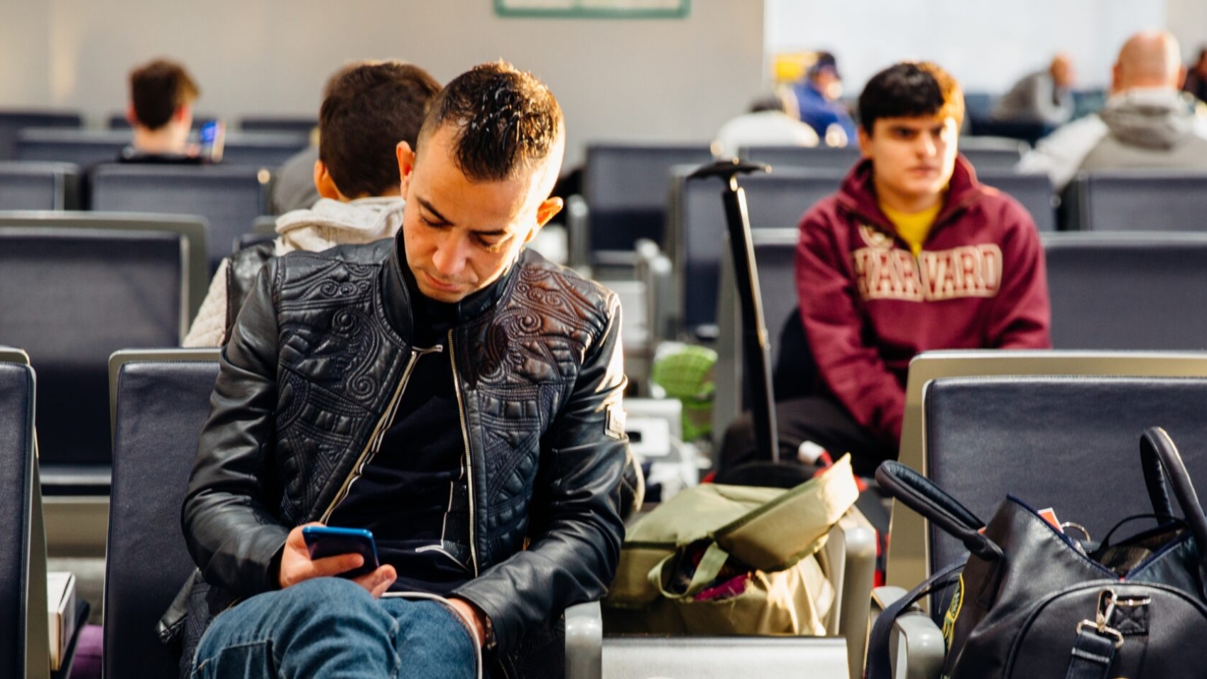Group passengers waiting at gate after airline disruption announcement