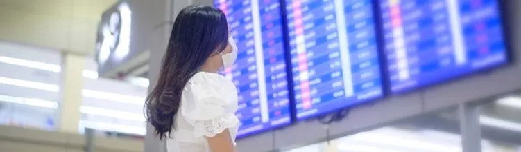 Airline passenger looking at the flight timetable on board