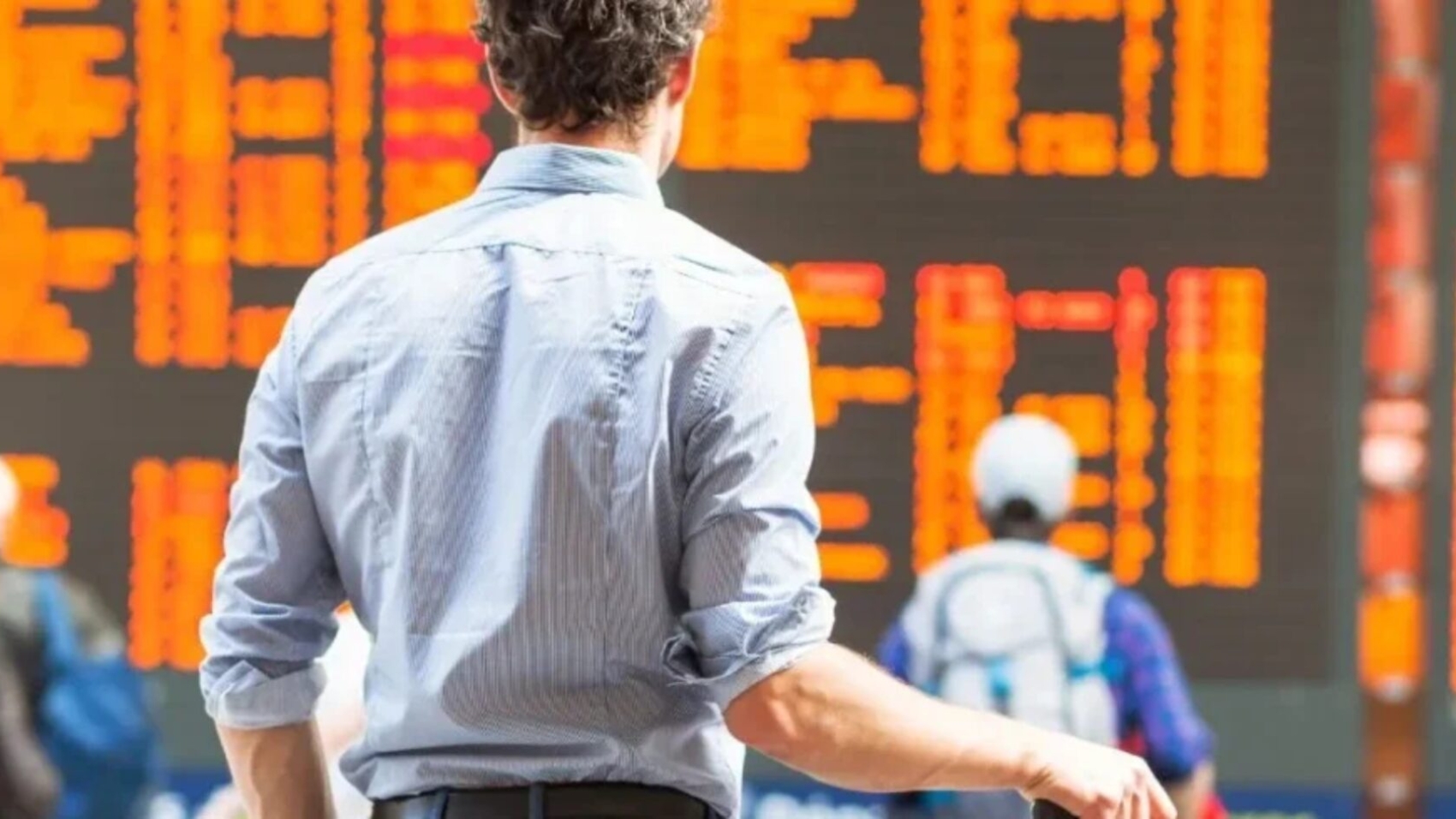 Airline passenger monitoring departure board for disruption updates