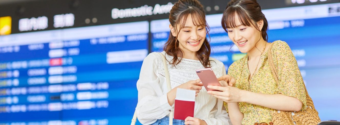 Passengers using mobile virtual assistant for flight updates at airport