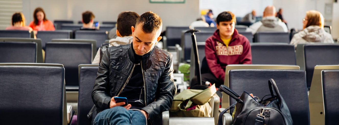 Group passengers waiting at gate after airline disruption announcement