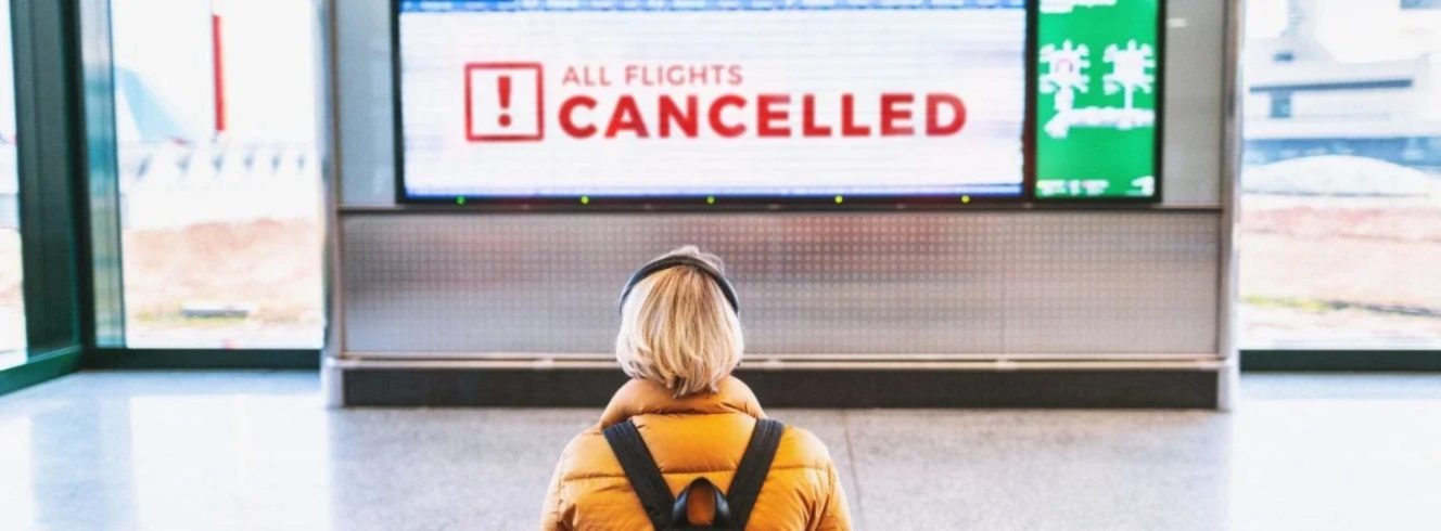 Passenger monitoring cancellations displayed on airport departure screen