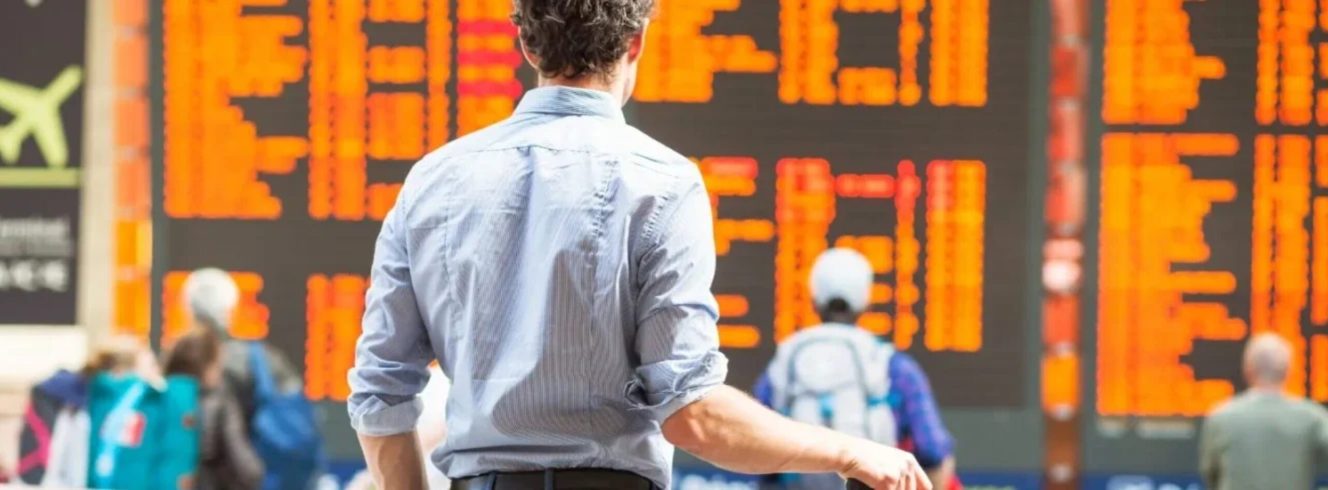 Airline passenger monitoring departure board for disruption updates