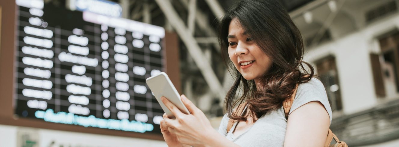Woman checking refund status on mobile during airline disruption